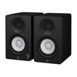 Par de monitores de estudio Yamaha HS4 negros, vista diagonal sobre fondo blanco