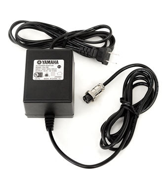 Adaptador de corriente Yamaha PA-10B, imagen oficial; verificar el código de fecha por el retiro de seguridad